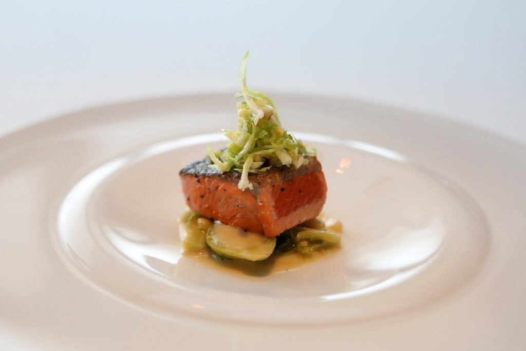 Sockeye salmon on braised Brussels sprouts and a beurre blanc was topped with shaved raw...