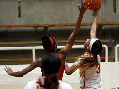Mesquite Horn guard Jasmine Shavers (3) puts up a layup as she is defended by Duncanville...
