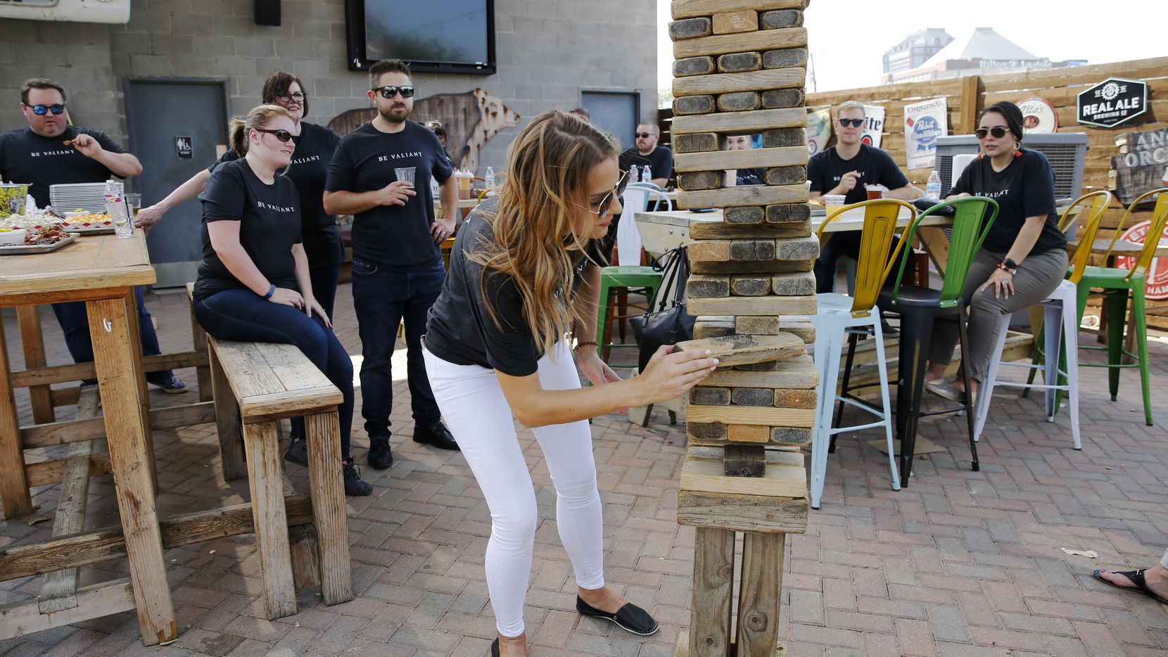 Emily Schroeder carefully removed a block of wood as she competed in a game of Jenga during an employee appreciation event for Valiant Residential employees.