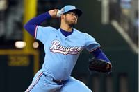 Texas Rangers starting pitcher Dane Dunning delivers against the Cincinnati Reds in the...