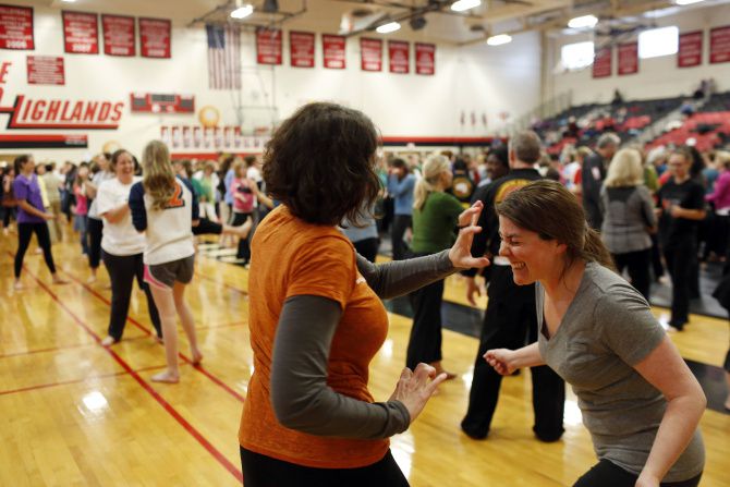Kamy Orear (left) and Katie May practice self-defense techniques during a free class at Lake...