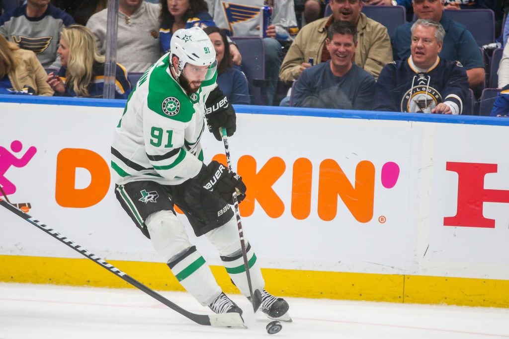 Dallas Stars Tyler Seguin (91) drives the puck up the ice as he is defended by St. Louis...