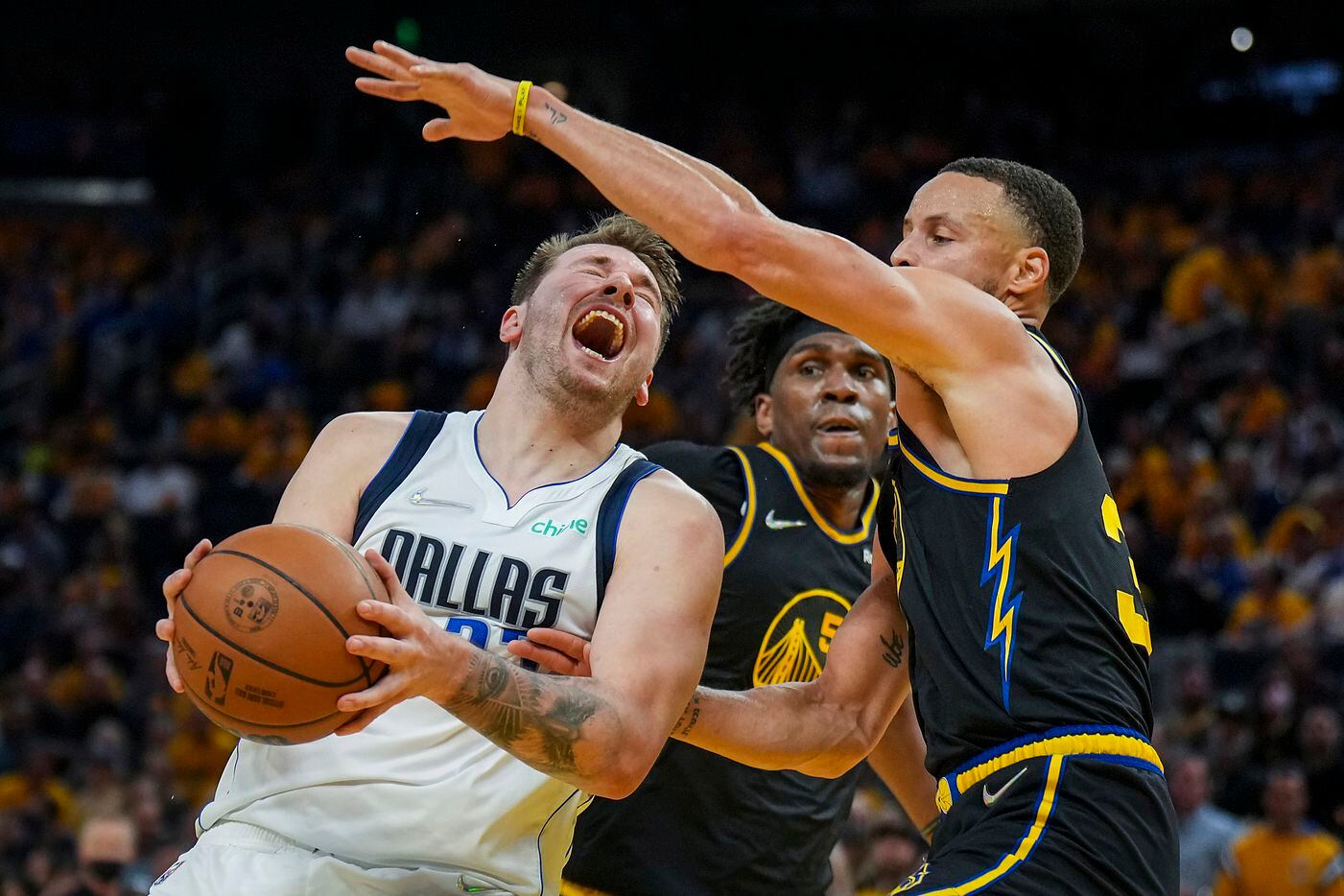 Dallas Mavericks guard Luka Doncic (77) is fouled by Golden State Warriors guard Stephen...