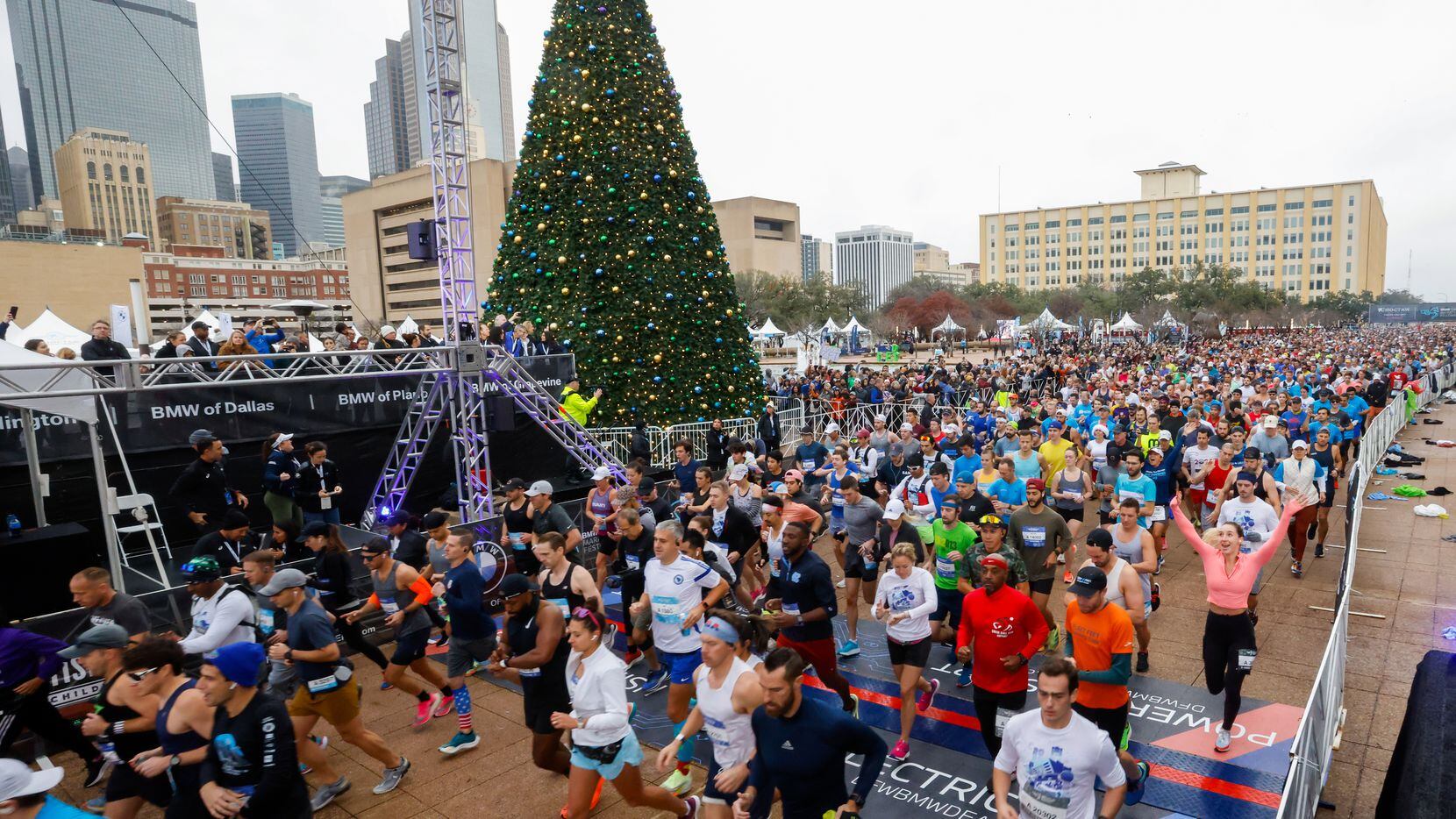 Runners cross the BMW Dallas Marathon start line in front of Dallas