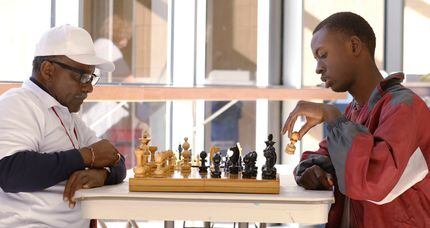 Donald Harris (left) plays chess with Duncanville High School student Gerald Watson during...