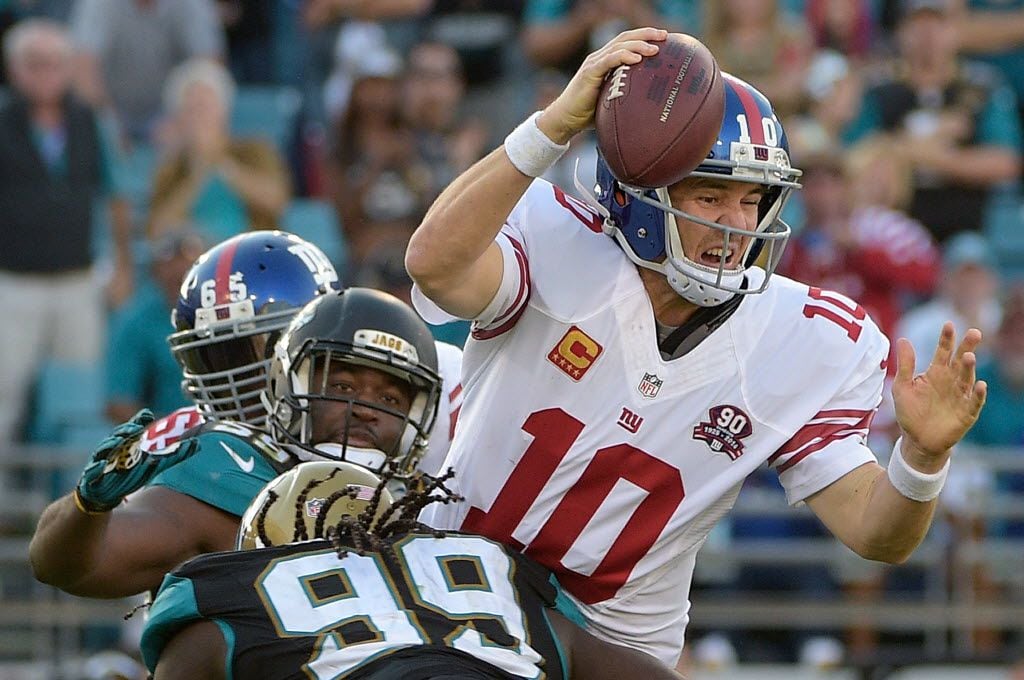 New York Giants quarterback Eli Manning (10) is sacked by Jacksonville Jaguars defensive...