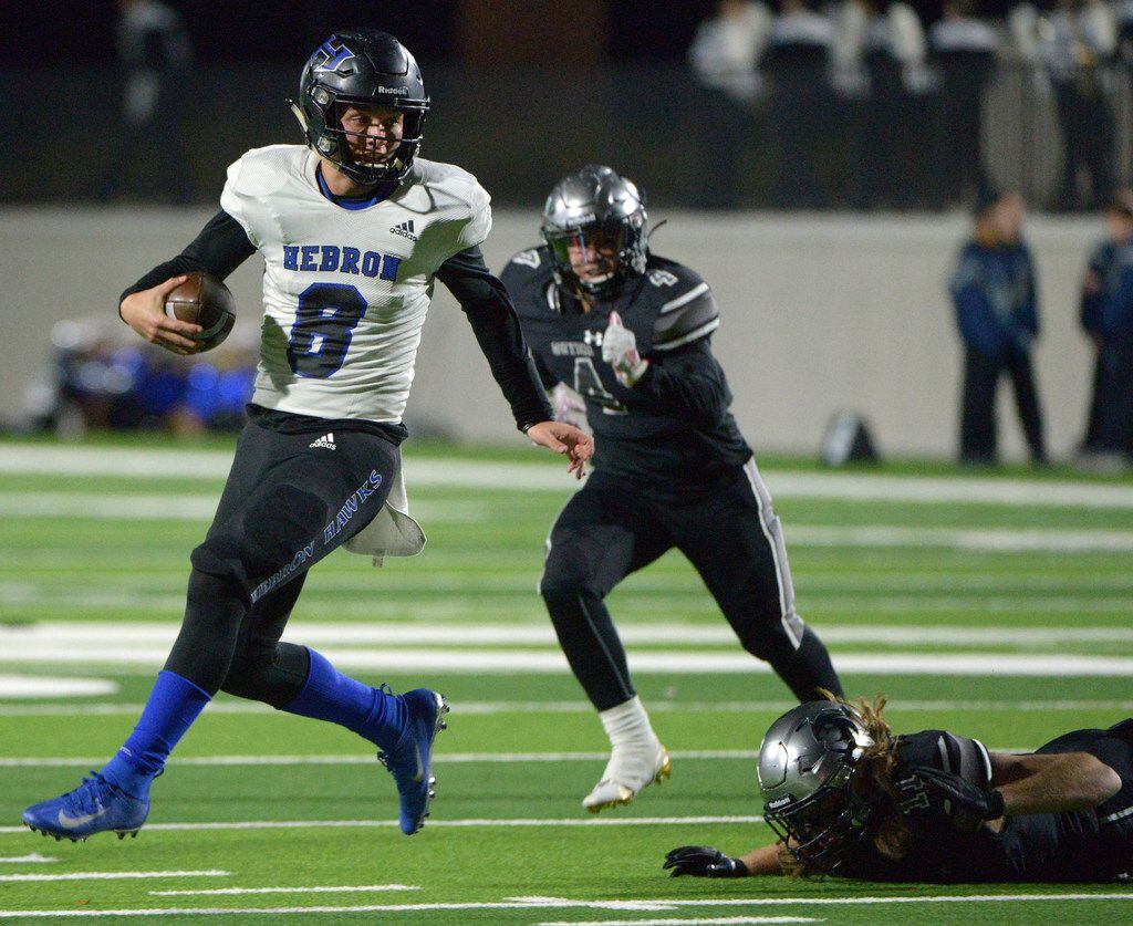Hebron's (8) Carson Harris high steps out of a tackle attempt by Guyer's Cole Ramsey in the...