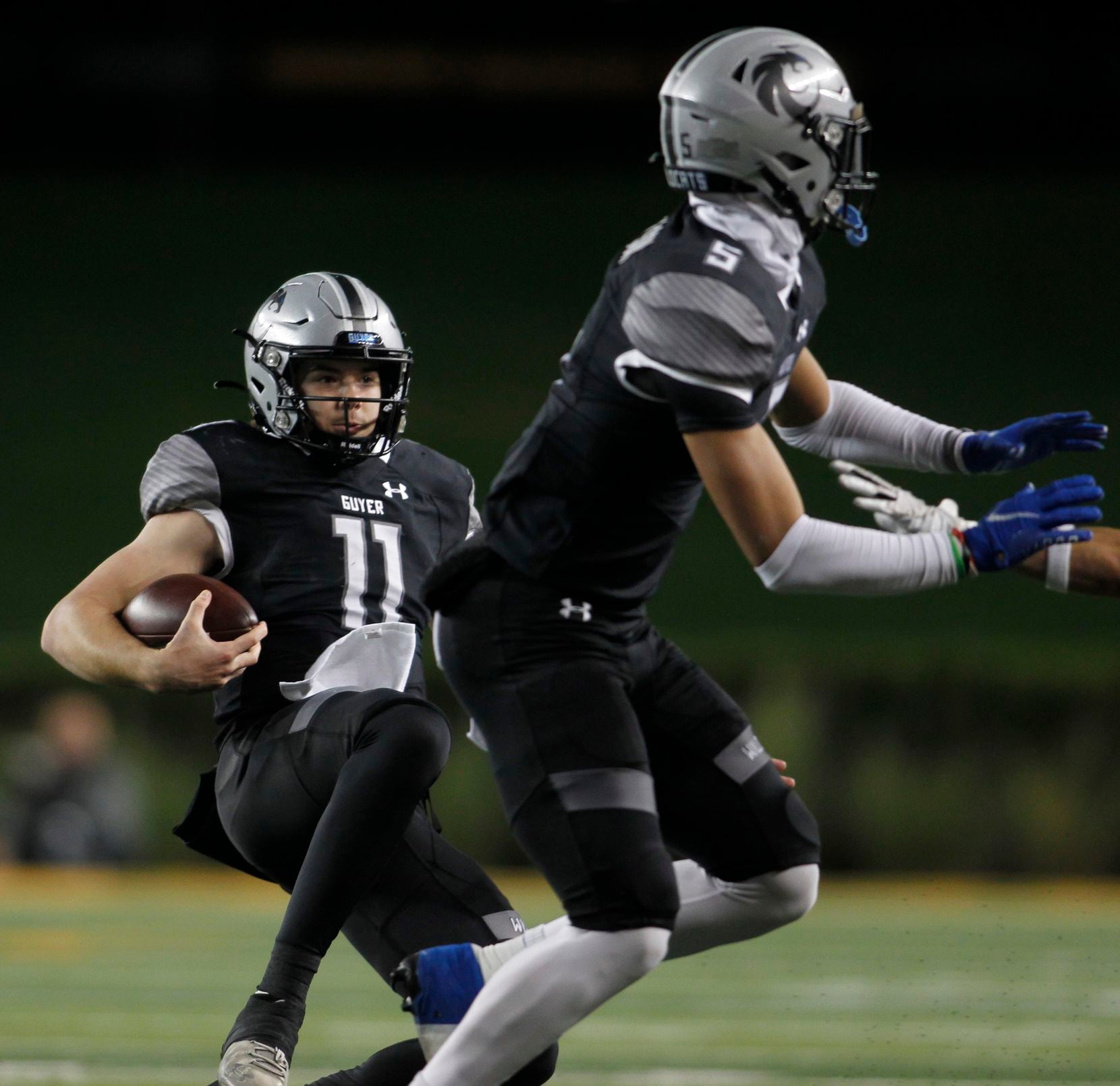 Denton Guyer quarterback Jackson Arnold (11) slides to avoid contact during a first quarter...