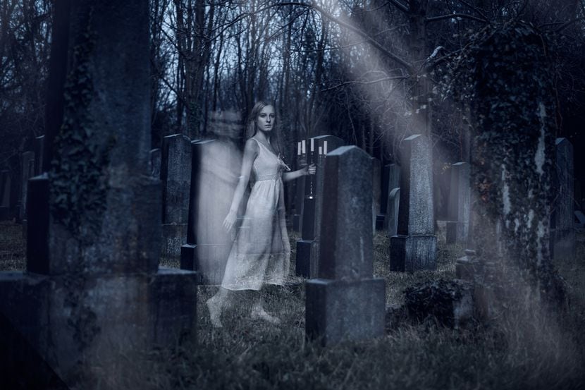 Ghost girl walking on cemetery. Halloween theme. 