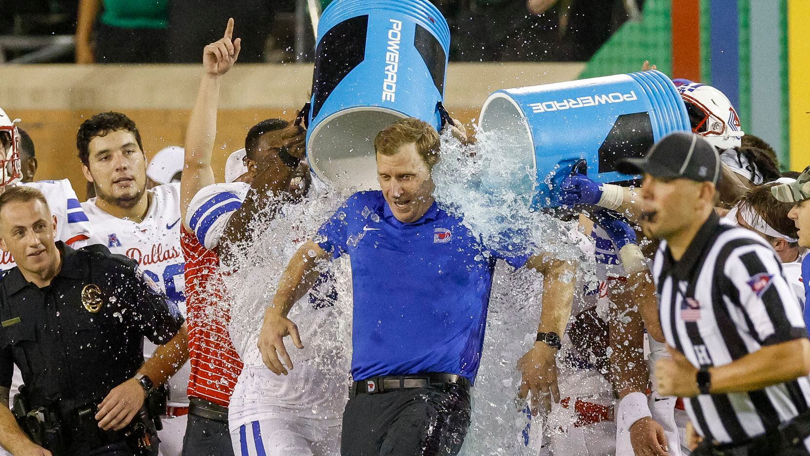 SMU head coach Rhett Lashlee is doused with ice water after a win against UNT at Apogee...