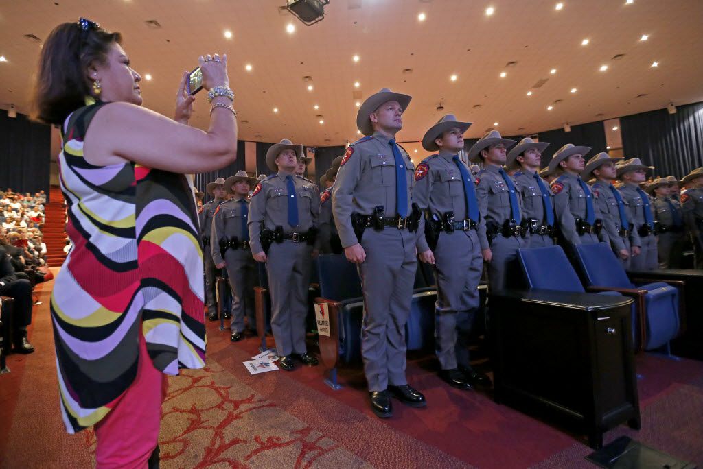 Janie Pierce (left) uses her cell phone to photograph members of the 155th trooper training...