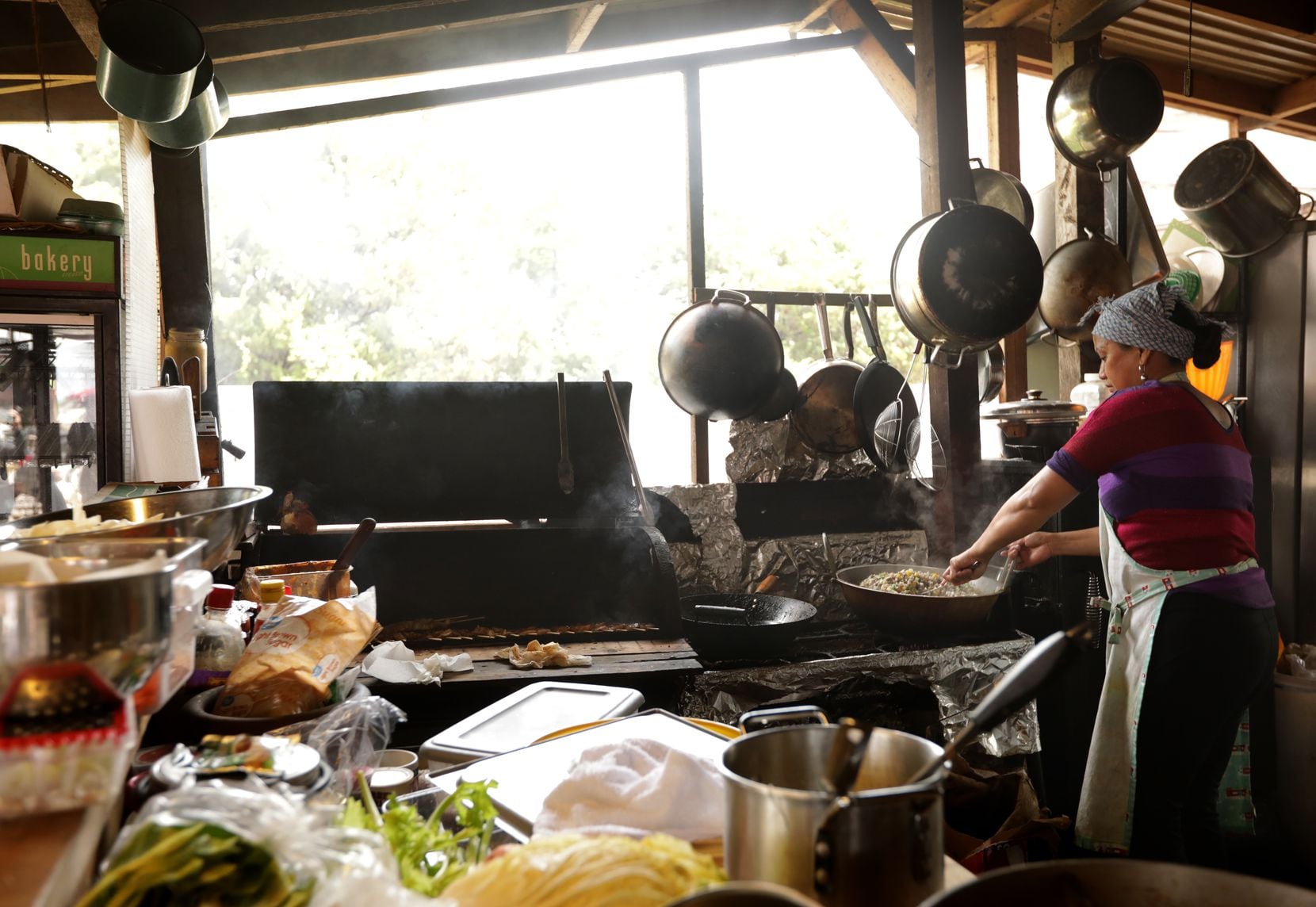 Josephine Cook prepares some food at Old Rooster Creek Filipino Asian/American BBQ.