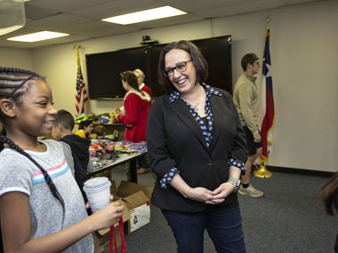 MJ Hegar chats with Azaria Jordan, 9, and her stepmother, Staff Sgt. Selina Robinson during her visit Operation Homefront's toy distribution event at the Army base in Austin. (Thao Nguyen/Special Contributor)