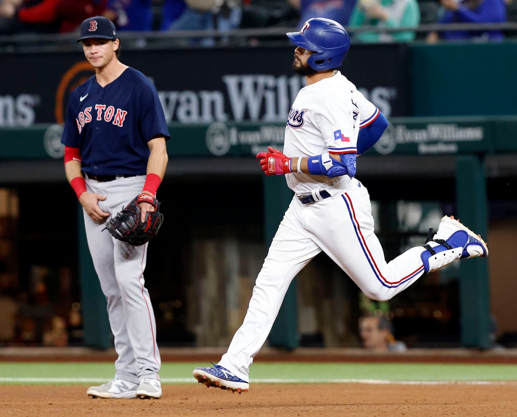 Texas Rangers Isiah Kiner-Falefa rounds the bases after his solo home run off of Boston Red...