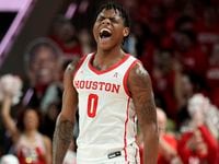 Houston guard Marcus Sasser reacts after making a 3-point basket during the first half of...