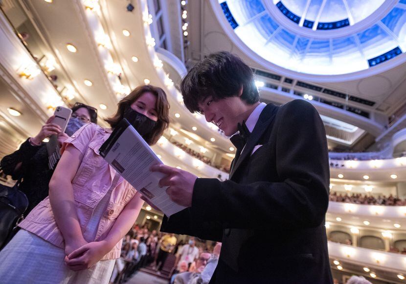 This year's Van Cliburn gold medalist Yunchan Lim, 18, of South Korea, signs his autograph...
