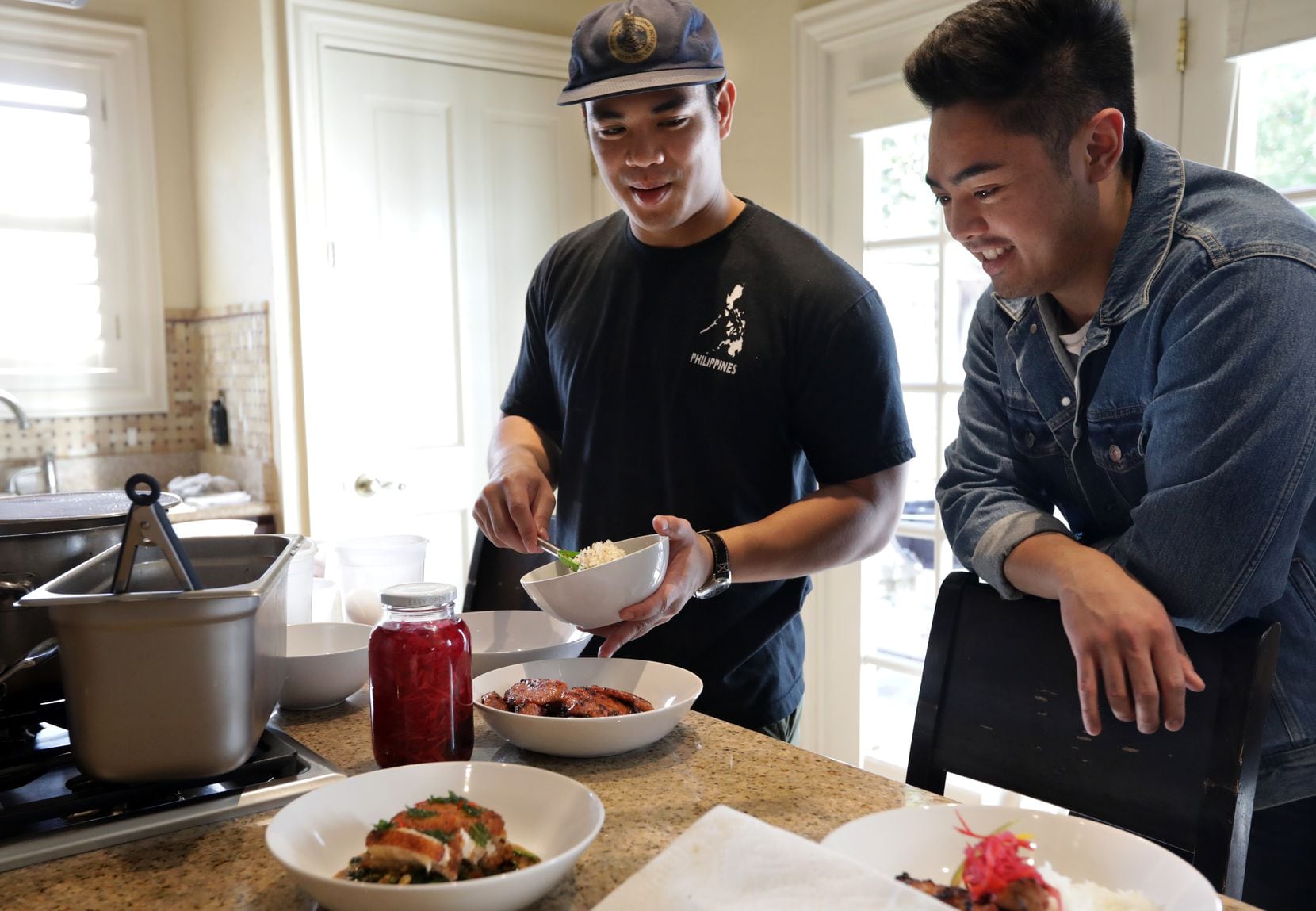 Jed Pajela, left, and Carlo Wayan of Not Your Lola's create Filipino dishes.