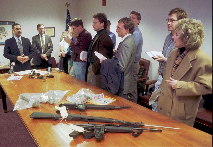 In January 1999, FBI agent Ted Jackson (far left) showed reporters the weapons and pipe...