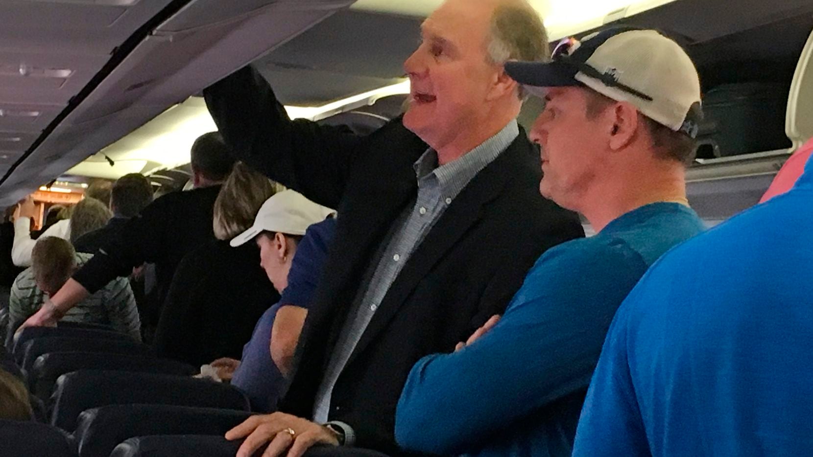 Southwest Airlines CEO Gary Kelly retrieves his bags from the overhead compartment after...