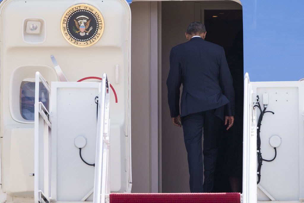 President Barack Obama boards Air Force One at Andrews Air Force Base to head to the Dallas...