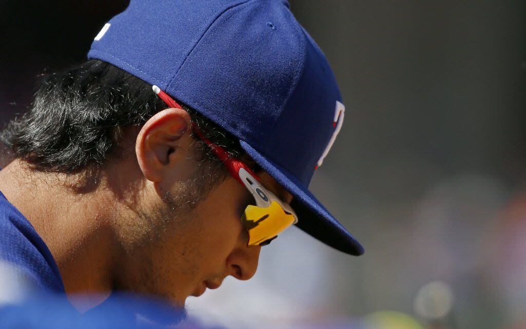 Texas Rangers starting pitcher Yu Darvish (11) hangs his head in the dugout at the end of...