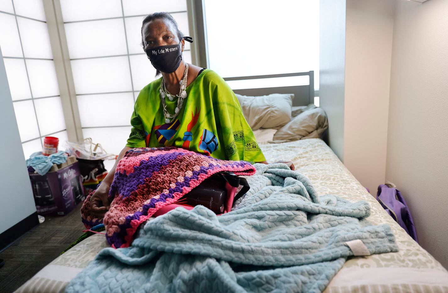 Patricia Freeman, 65, found her way to The Bridge Homeless Recovery Center in downtown Dallas earlier this year after nearly freezing to death at a Houston bus stop during February's deadly storm. She plans on getting settled into more permanent place with Rapid Rehousing under the assistance of her case manager Amanda Crowe. Patricia is photographed in her transitional room with a blanket she is crocheting at The Bridge, Thursday, July 29, 2021. (Tom Fox/The Dallas Morning News)