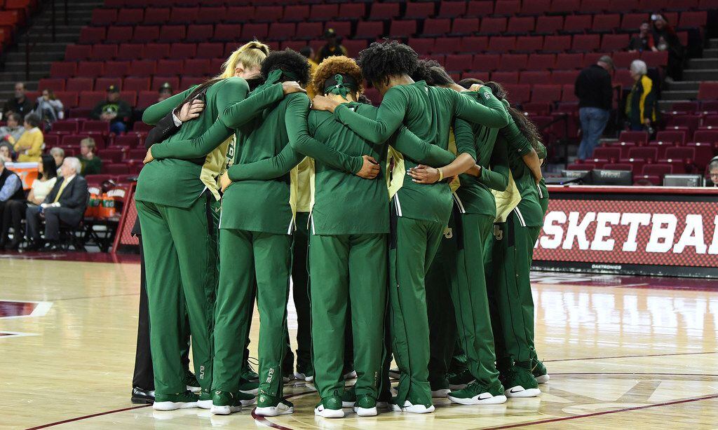 Baylor players huddle together before an NCAA college basketball game against Oklahoma in...