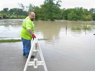 Marco Medrano, from City of Dallas Public Works Department, puts out a barrier to close...