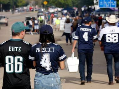 A Dallas Cowboys and Philadelphia Eagles fan walk to the Monday Night Football game at AT&T...