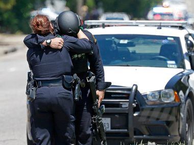 Two Dallas Police Officers comfort each other on the active shooting scene where a Dallas...