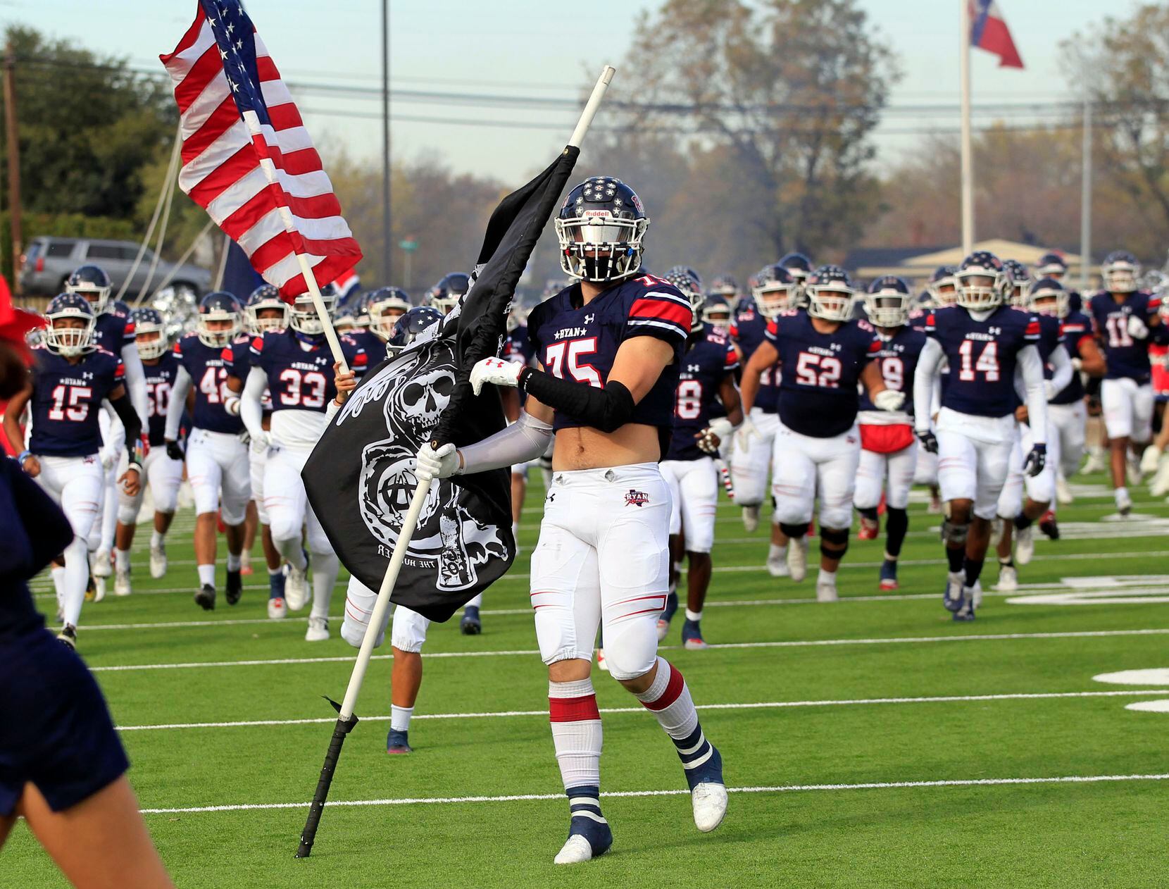 Denton Ryan’s Ethan Wood (75) and his teammates enter the field before the first half of...