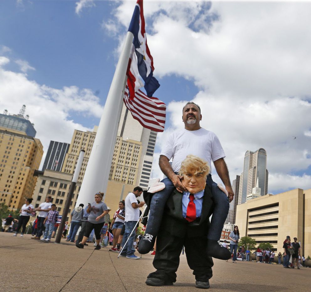 Ernesto Lazarraga walks on the Dallas City Hall Plaza after participating in the Mega March,...