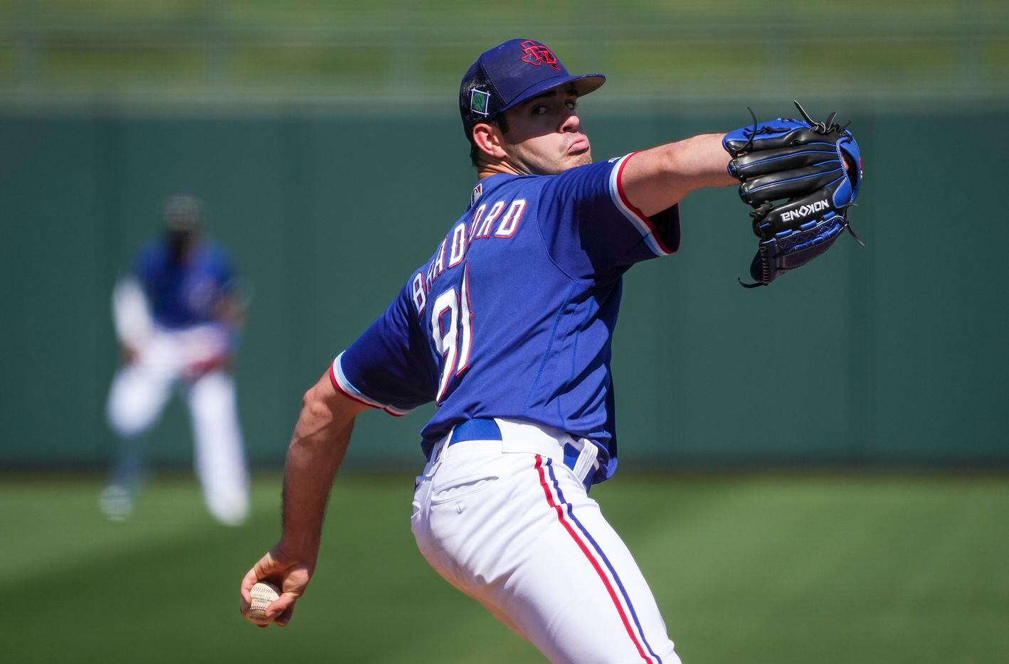 Texas Rangers pitcher Cody Bradford delivers during the third inning of a spring training...