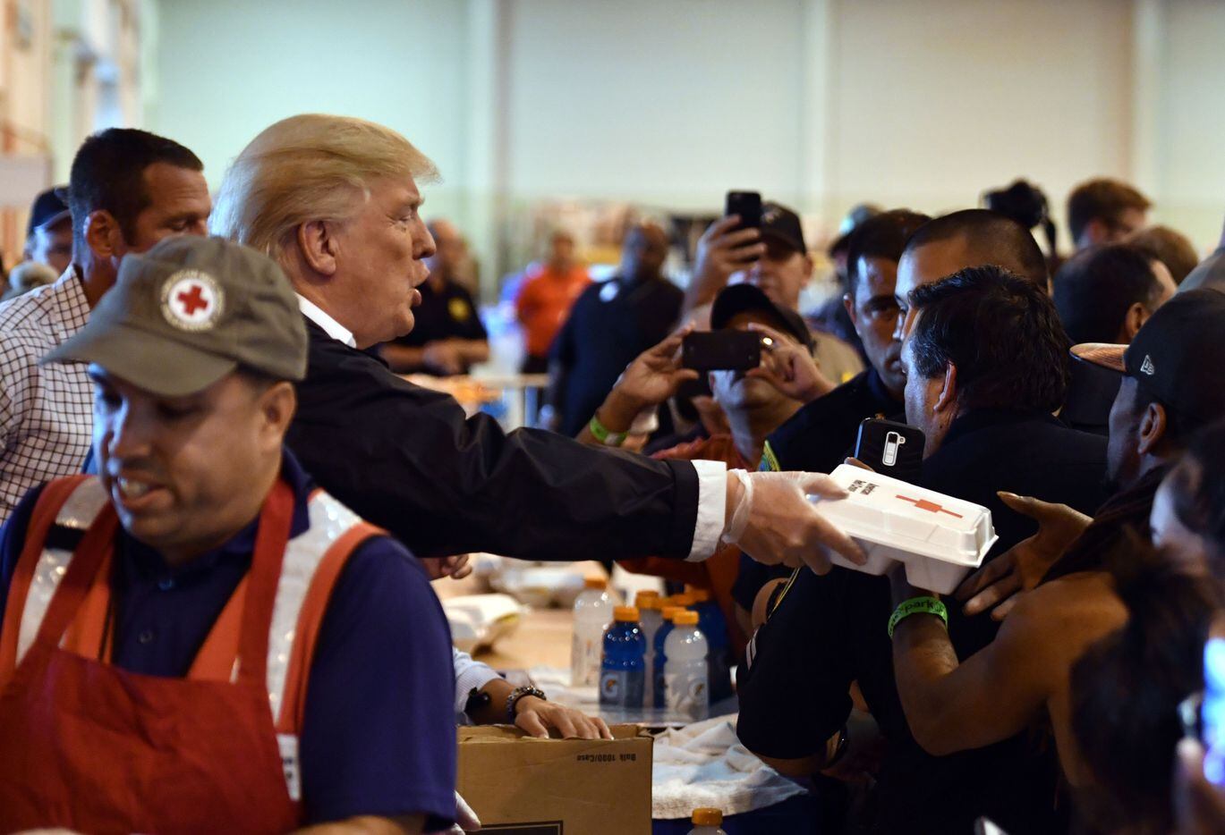 President Donald Trump serves food to Hurricane Harvey victims at NRG Center in Houston on...