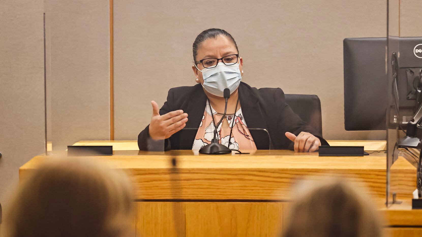 Dallas Police Detective Christine Ramirez talks on the stand during a hearing conducted by...