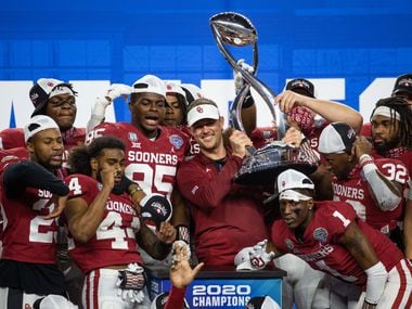 Oklahoma Sooners head coach Lincoln Riley holds up the Cotton Bowl champions’ trophy and celebrates with his team during the post-game ceremony following the Goodyear Cotton Bowl Classic football game on Thursday, Dec. 30, 2020.