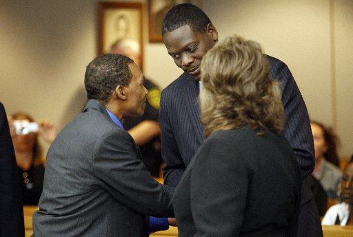 Johnnie Lindsey shakes hands with then-Dallas County District Attorney Craig Watkins, after...