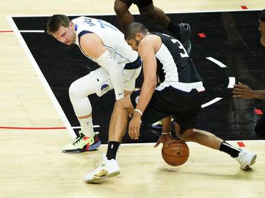 Dallas Mavericks guard Luka Doncic (77) has the ball knocked away by LA Clippers forward...