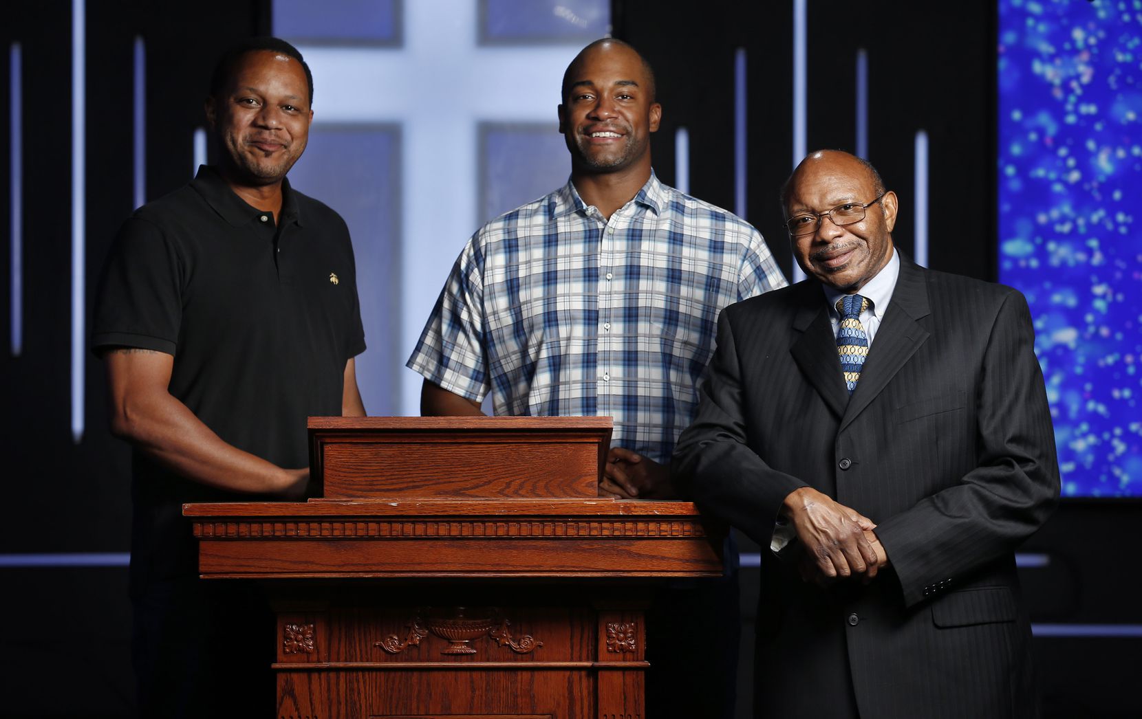Pastor Chris Simmons (right) at the lectern with Donald Wesson (center), program director of the church's nonprofit arm, and Ernest Baylor, who oversees Bible lessons, at Cornerstone Baptist Church in Dallas.