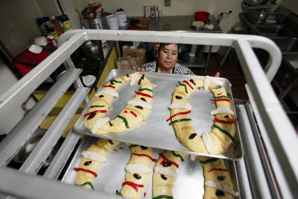 Baker Maria Macrina Hernandez places a Rosca de Reyes on cart prior to baking at Maroches...