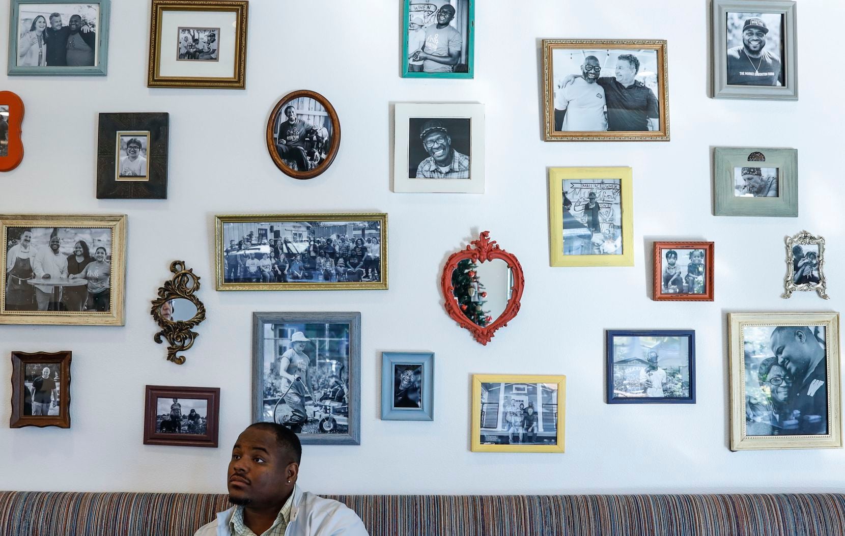 Clifton Reese, one of Bonton Farms' key directors, at the operation's Market Cafe, where a "story wall" tells of the lives of the people who make up the community. "Every picture you see shares a story of what we talk about — love, courage and unity," Reese says.