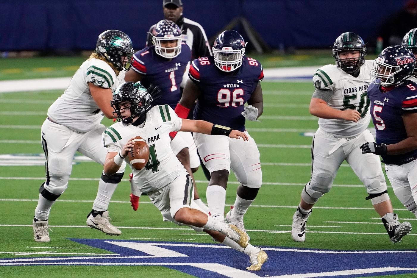 Cedar Park quarterback Ryder Hernandez (4) is flushed from the pocket by Denton Ryan defensive lineman Bear Alexander (96) during the second half of the Class 5A Division I state football championship game at AT&T Stadium on Friday, Jan. 15, 2021, in Arlington, Texas. Ryan won the game 59-14. (Smiley N. Pool/The Dallas Morning News)