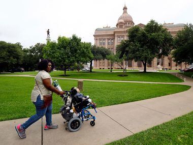 Linda Badawo of Mesquite, Texas pushes her 3 yr-old son D'ashon Morris to the Texas State...