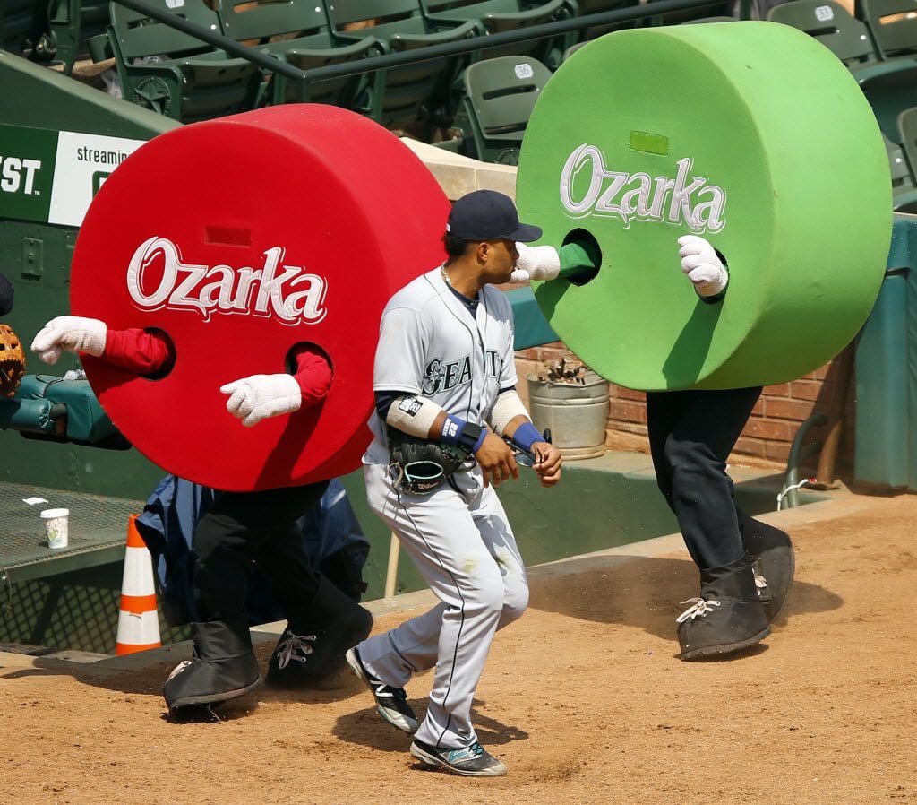 Seattle Mariners second baseman Robinson Cano (22) tries to dodge the Dots racing down the...