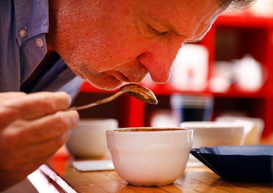 Founder Russell Hayward breaks the crust and judges the aroma of a specific coffee roast at...