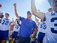 TCU head coach Sonny Dykes celebrates a victory over SMU with his team after an NCAA college...