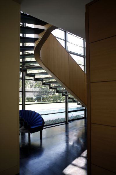 The open, curvaceous stairway in the Greenway Parks house allows more light to filter in.