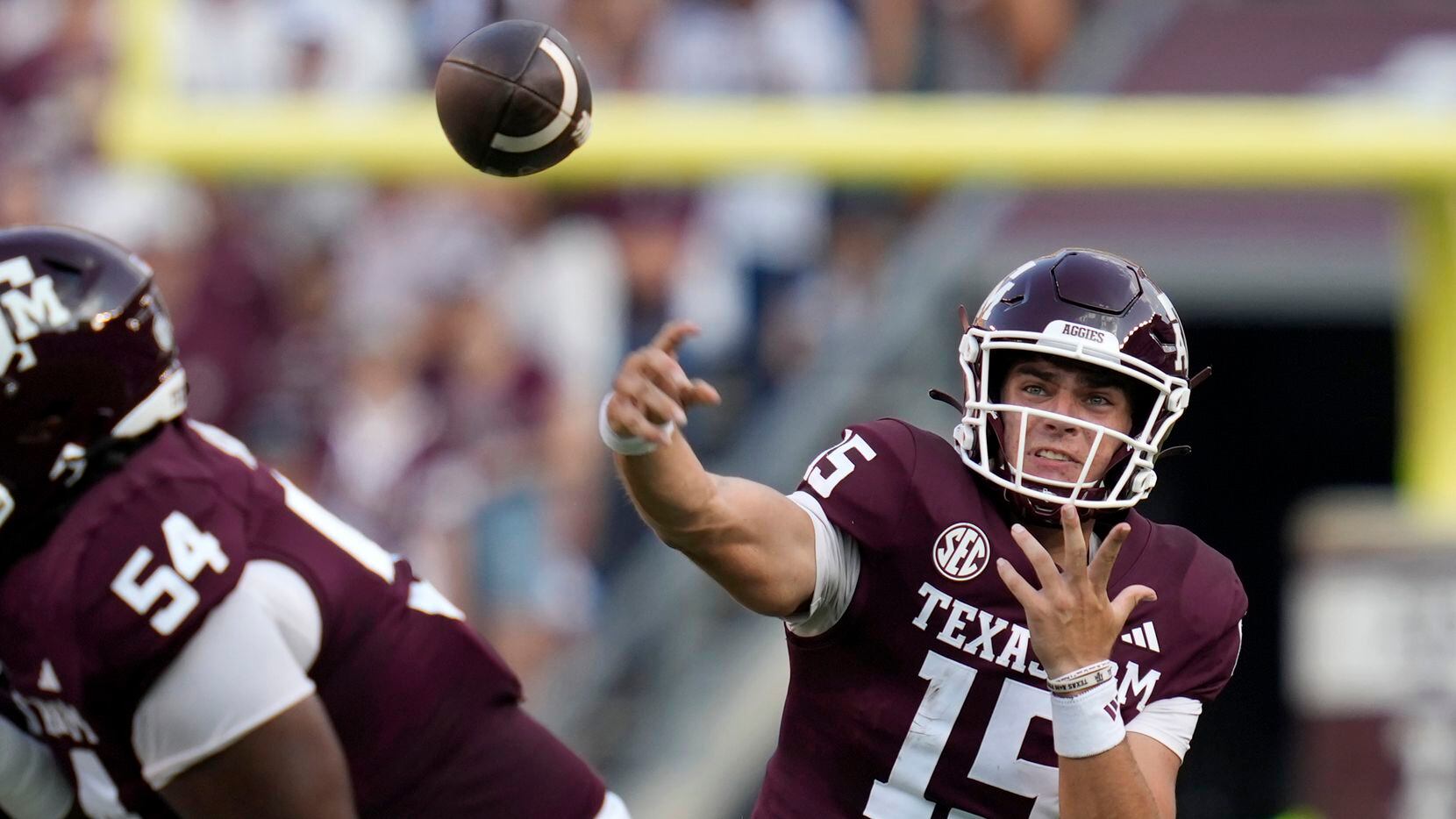 Texas A&M quarterback Conner Weigman (15) pass down field for a completion against New...