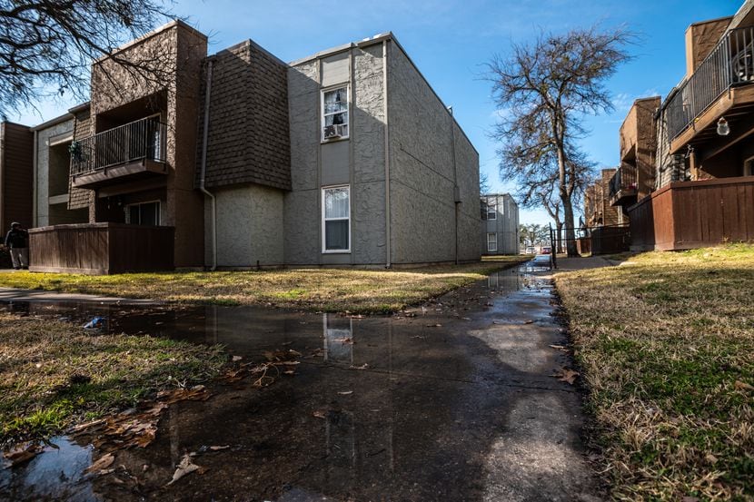 Sewer water floods the sidewalks outside of units at the Hillcrest apartments in Mesquite,...