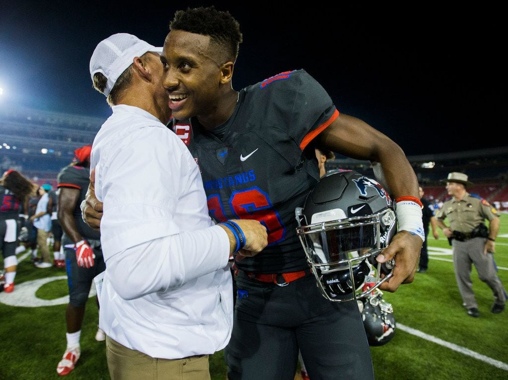 Southern Methodist Mustangs wide receiver Courtland Sutton (16) gets a hug from head coach Chad Morris after a 44-21 win over the Arkansas State Red Wolves on Saturday, September 23, 2017 at Ford Stadium on the SMU campus in Dallas. (Ashley Landis/The Dallas Morning News) 
